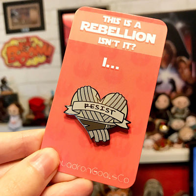 Rey of Jakku enamel pin with the text 'Resist'