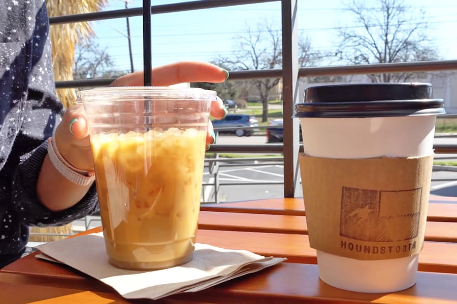 Closeup of an iced vanilla latte and hot vanilla latte from Houndstooth coffee Austin